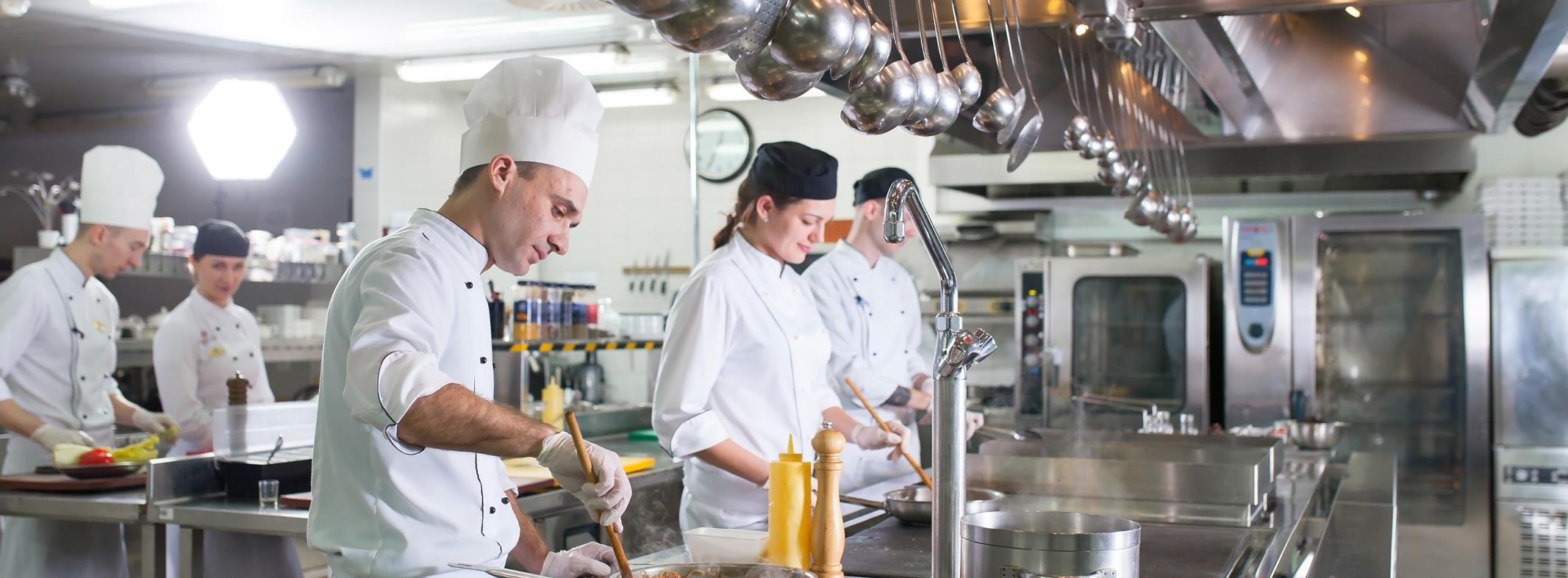Kitchen staff cooking during the busy hour